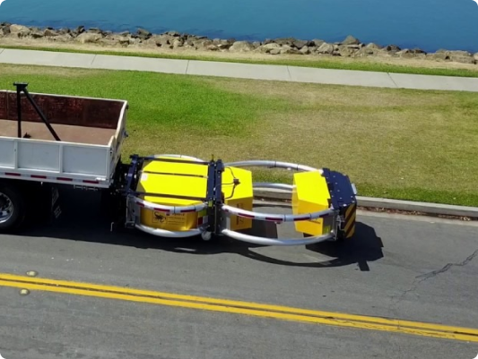 a yellow and silver trailer on the road